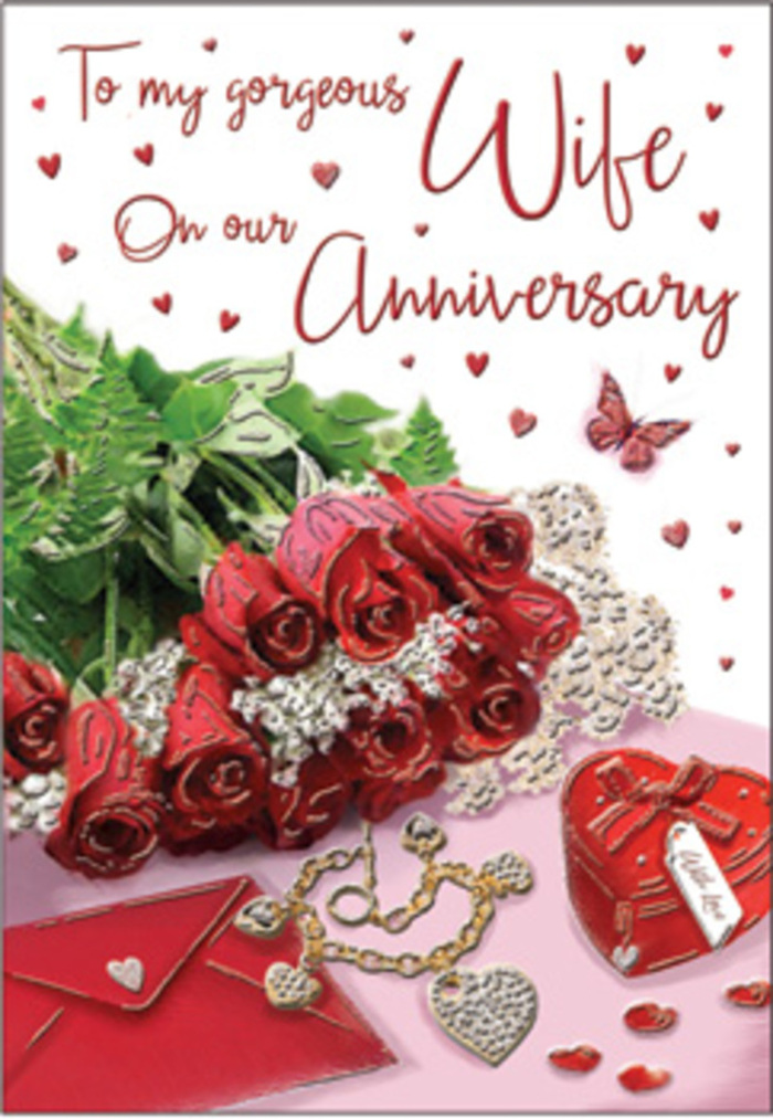 In this evocative anniversary card image, the arrangement unfolds like a cherished vignette from a Worcester Park couple's years together. At centre stage stands a bouquet of timeless red roses, each bloom generously full, the petals layered in soft spirals that move from deep, velvety crimson at the base to gentle highlights at the edges. The roses are elegantly wrapped, secure yet relaxed, reminiscent of a hand-tied arrangement collected from a trusted local florist on the way home. Interwoven amongst them, lush greenery adds volume and depth, its rich tones amplifying the drama of the red petals much like the green spaces and tree-lined avenues that characterise Worcester Park. Around the bouquet, fine decorative touches tell a story of treasured celebrations: whisper-thin lace details and dainty heart motifs drift across the design, their delicate textures sitting in contrast to the smooth card surface. A jewellery set rests beside a bold red gift box, the box robust and vivid, its lid suggesting a special anniversary present just exchanged between partners. Hints of velvet, gleaming gold, and imagined silk thread through the scene, evoking the feeling of dressing up for a rare evening out or a quiet dinner at home. Warm, flattering lighting glows across the composition, casting subtle reflections and shadows that make each element feel tangible, as if you could reach out and touch the satin petals or cool metal. The scripted message on the card curves in graceful lines, reinforcing the sense of a carefully composed declaration of love. Taken together, the image captures a mood of deep romance and lasting connection, ideal for honouring years of companionship in Worcester Park, from first meetings to well-worn shared routines.