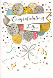 This photograph captures a chic congratulations card whose design feels like a party distilled onto paper, much like the cheerful atmosphere along Central Road in Worcester Park on a weekend. The card's main illustration is a loose cluster of balloons, gently rising from the lower portion toward the top, suggesting a sense of upward movement and hope. The balloons themselves are painted in a soothing palette of metallic gold and silver, complemented by champagne tones, soft sky blue, petal pink, and subtle grey. Patterns of tiny stars, neat stripes, and scattered glitter-like dots decorate different balloons, giving the impression of light reflecting off their smooth surfaces. Fine ribbons and strings, rendered in graceful strokes of gold and silver, dangle and swirl from the balloon knots, converging into a small, decorative flourish that anchors the design. Surrounding the main cluster, the background is sprinkled with small metallic stars, dots, and curling lines that resemble floating confetti and streamers, all set against a creamy, almost luminous backdrop. Cutting through the centre of the balloon bouquet is a banner that looks gently unfurled, carrying the words "Congratulations To You" in flowing, stylish script that conveys warmth, admiration, and sincerity. There is a subtle suggestion of texture in the glitter details and glossy ink, which invites the viewer to imagine the feel of the card in their hands. The overall effect is polished yet joyful, making this card a perfect companion to a celebratory arrangement from a local Worcester Park florist for exam successes, work milestones, or any achievement that deserves a radiant, memorable tribute.
